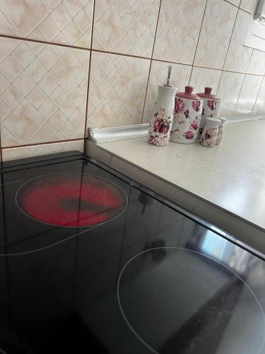 a kitchen counter with a black stove top oven at MARIALENA HOMe in Petropiyí