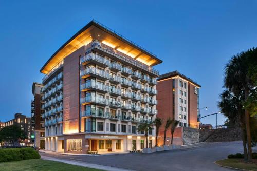 a tall building with lights on the side of it at AC Hotel Savannah Historic District in Savannah