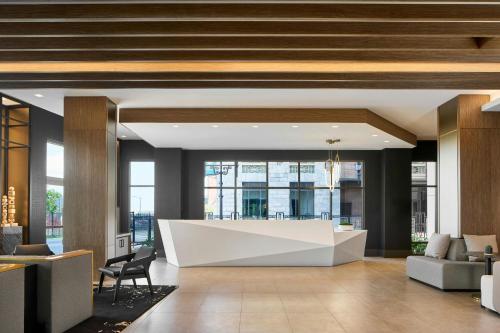 a lobby with a reception desk in a building at AC Hotel Savannah Historic District in Savannah