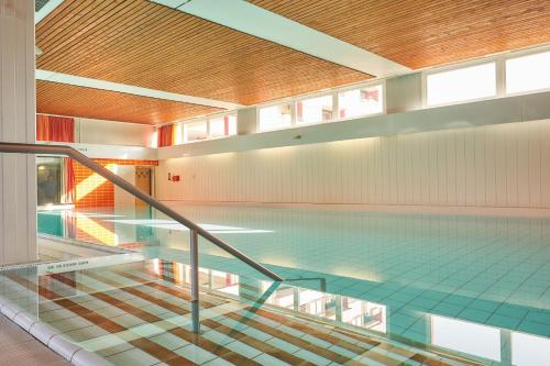 a swimming pool in a building with a glass floor at Berolina Badebude 214 in Dahme