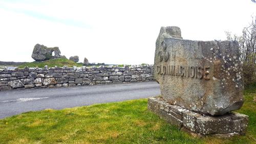 a stone sign sitting on the side of a road at Ely House B&B in Shannonbridge