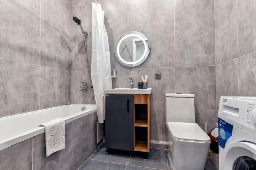 TaldykolʼにあるRaisson Ahotel Headliner E39-Khan Shatyrの洗面台、トイレ、鏡のあるバスルーム