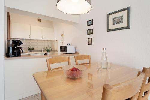 a kitchen with a table with a bowl of fruit on it at Schützenweg 6 Ostseesonne in Kellenhusen