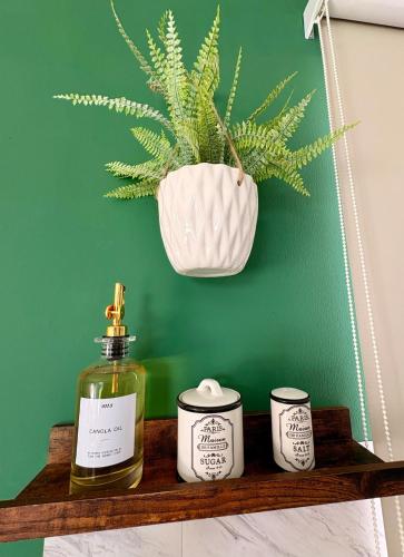 a shelf with a bottle of perfume and two candles at Private Suite with Terrace & Jacuzzi in Mérida