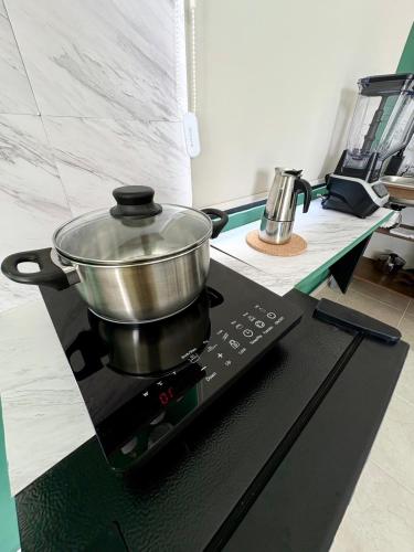 a pot on top of a stove in a kitchen at Private Suite with Terrace & Jacuzzi in Mérida