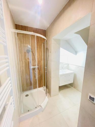 a bathroom with a shower and a sink at Sopot Modern Apartments 3 in Sopot