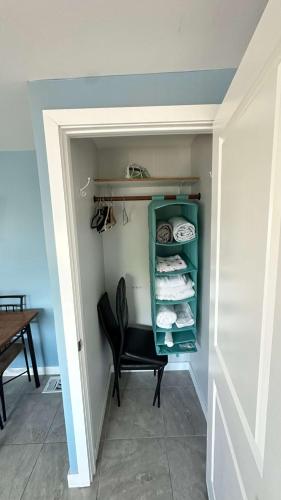 a walk in closet with a chair and a table at Big Studio with Ocean View max 6 sleepers in San Diego