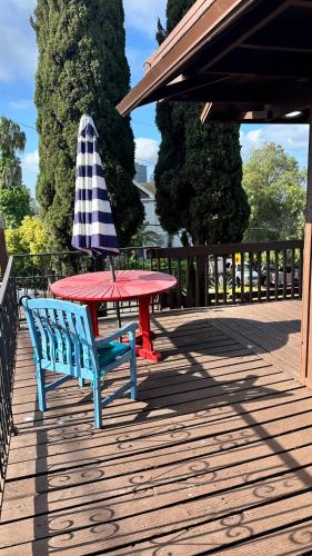 a picnic table and an umbrella on a deck at Big Studio with Ocean View max 6 sleepers in San Diego