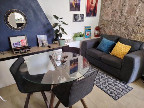 a living room with a glass table and a couch at Tiny House in Guanajuato