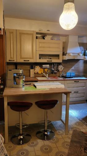 a kitchen with a table and two bar stools at Private house in Baone