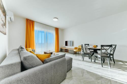 a living room with a couch and a dining room at ARA Lux Apartments in Utjeha