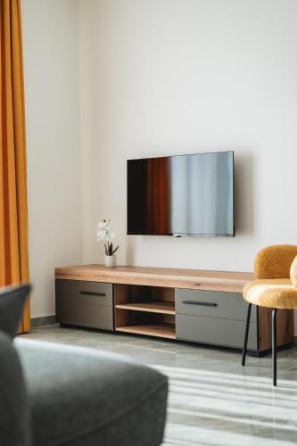 a living room with a flat screen tv on a wall at ARA Lux Apartments in Utjeha