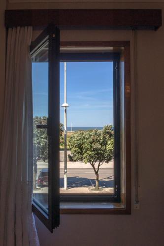 a window with a view of a tree at Vista Atlântica-Vila do Conde in Vila do Conde