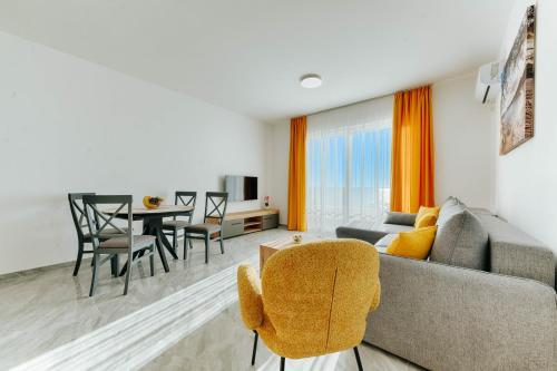 a living room with a couch and a table at ARA Lux Apartments in Utjeha