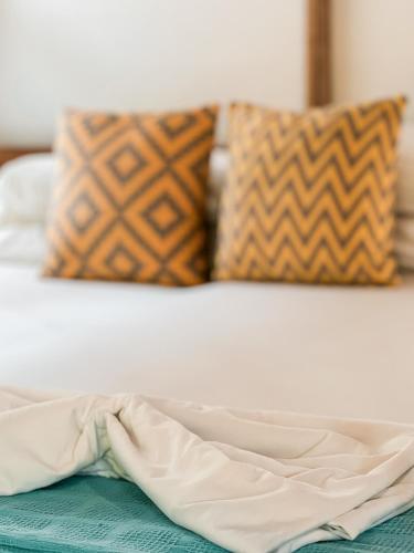 a close up of a bed with a sheet on it at Nubá Boutique Hostel Palomino in Palomino