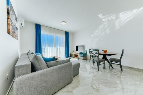 a living room with a couch and a table at ARA Lux Apartments in Utjeha