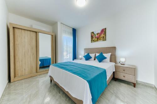 a bedroom with a large bed and a large window at ARA Lux Apartments in Utjeha