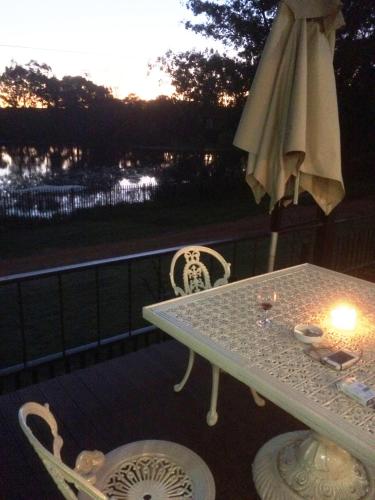 a table and chairs on a balcony with a candle at Bri-Shel Manor B&B in Heidelberg