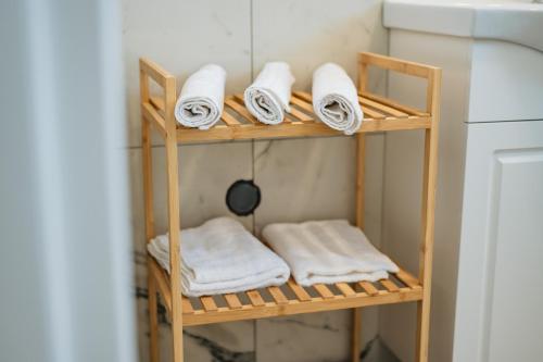 a shelf with towels on it next to a refrigerator at ARA Lux Apartments in Utjeha