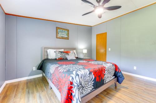 a bedroom with a bed and a ceiling fan at Palatka Hideaway with Fireplace and Private Porch in Clay Landing