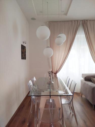 a dining room with a glass table and chairs at Carneval and Tuscany in Viareggio