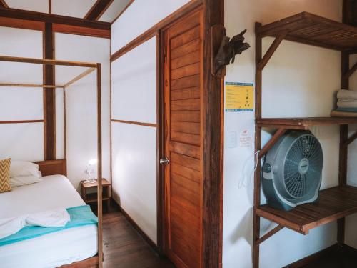 a bedroom with a bunk bed and a fan at Nubá Boutique Hostel Palomino in Palomino