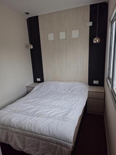 a large bed in a room with a window at Complejo Paso de los Andes in Rivadavia