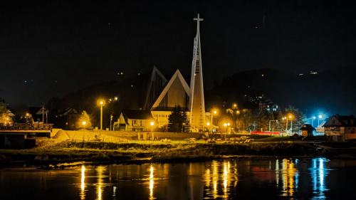 a church with a steeple and a cross at night at Słoneczne Domki in Krościenko