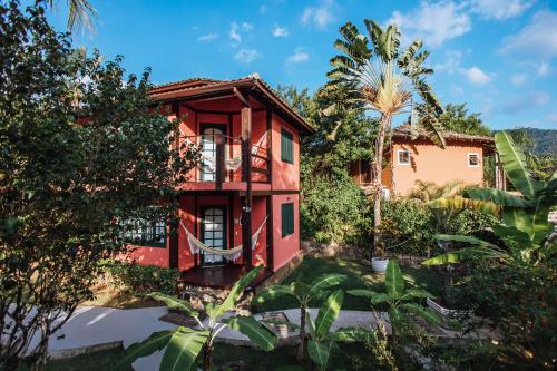 a house in the middle of a garden at Pousada Vila das Pedras in Ilhabela