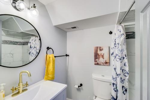 a bathroom with a sink and a mirror at Newly Renovated Abode with Patio in Baltimore! in Baltimore