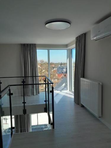 a room with a staircase and a large window at Art Boulevard in Mrzeżyno