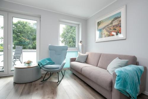 a living room with a couch and a chair at Lucia in Scharbeutz