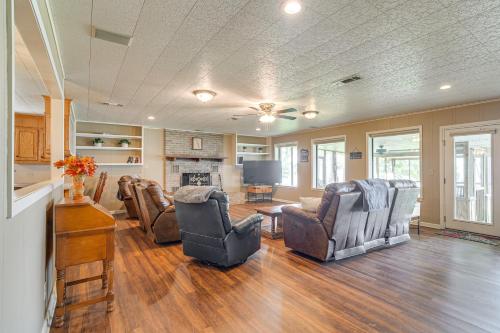 a living room with chairs and a couch and a television at Lakefront Gem with Boat Dock and Fishing Pier in Many in Many