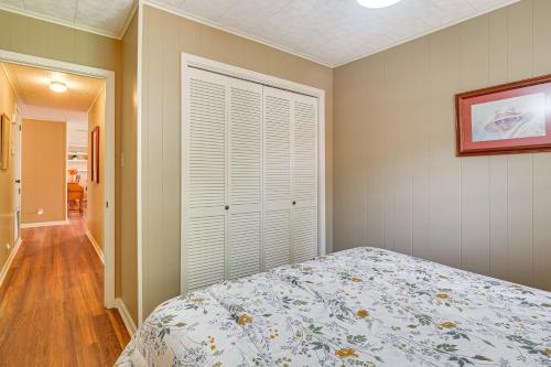 a bedroom with a bed and a closet with a window at Lakefront Gem with Boat Dock and Fishing Pier in Many in Many