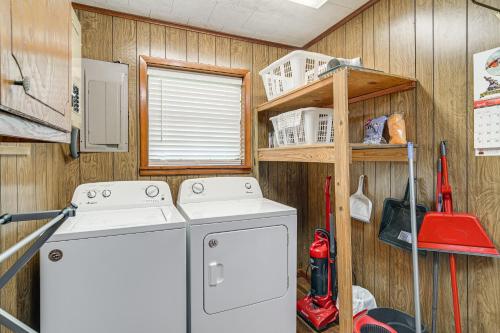 a kitchen with a washing machine and a wooden wall at Lakefront Gem with Boat Dock and Fishing Pier in Many in Many