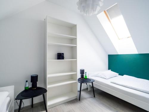 a bedroom with a bed and two stools at Słoneczne Domki in Krościenko