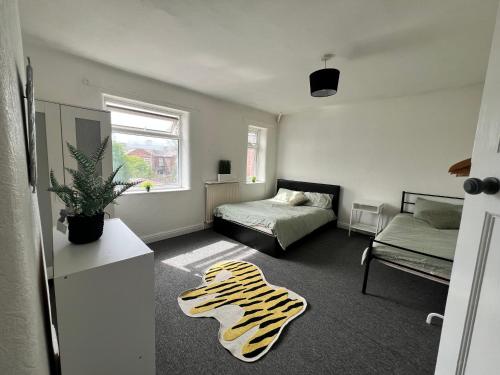 a room with a bed and a zebra rug at Spacious House Close to Central Manchester With Free Parking in Manchester