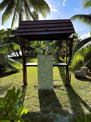 a small pavilion in a park with palm trees at MOOREA - Sundara Soul Villa in Hauru