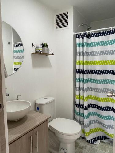 a bathroom with a toilet and a shower curtain at CC Fundadores, cerca sector el Cable y CC Mall Plaza in Manizales
