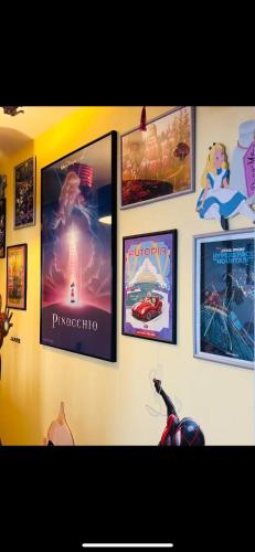 a wall with pictures of movies on it at THE ENCHANTED HOUSE ( 15 min walk to Disney) in Serris