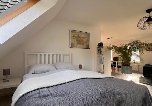 a bedroom with a large bed and a staircase at Ferienwohnung Sonnenblick in Detmold