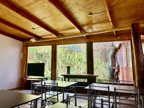 a room with tables and chairs and a large window at turisolcor atacama in San Pedro de Atacama
