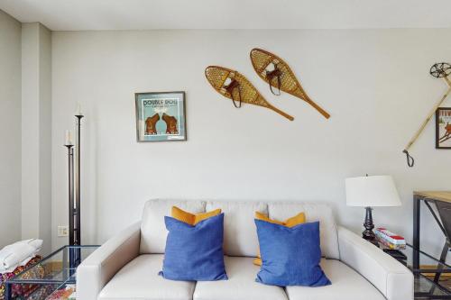 a living room with a white couch with blue pillows at Passage Point 422 in Copper Mountain
