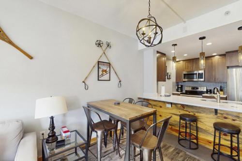 a kitchen and dining room with a table and chairs at Passage Point 422 in Copper Mountain