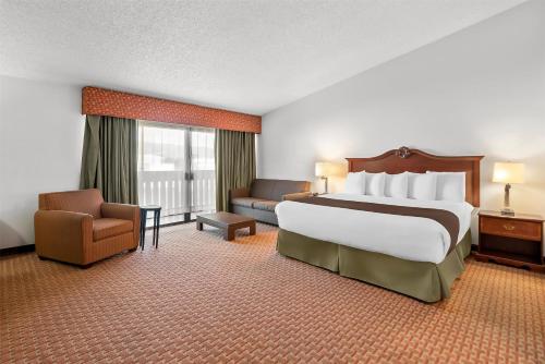a hotel room with a large bed and a couch at Best Western Chieftain Inn in Wenatchee