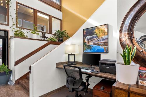 an attic office with a desk with a computer on it at Best Western Chieftain Inn in Wenatchee