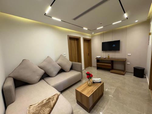 a living room with a couch and a tv at Ramage Hotel & Resort in Cairo