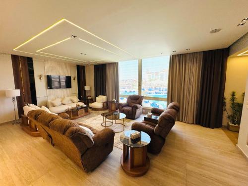 a large living room with couches and a tv at Ramage Hotel & Resort in Cairo