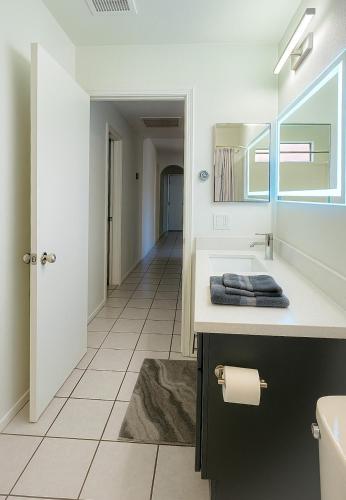 a bathroom with a sink and a mirror at North Phoenix At Your Fingertips in Phoenix