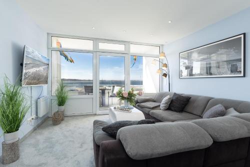 a living room with two couches and a large window at Aloha Suite in Fehmarn